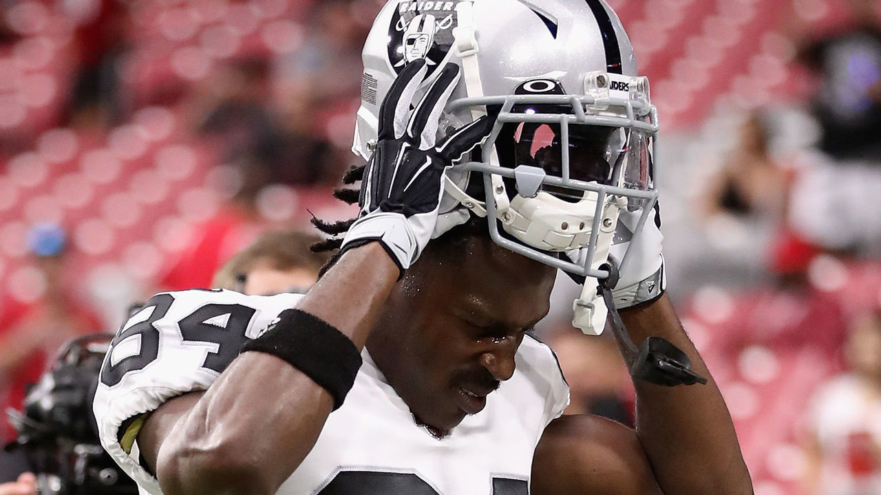 GLENDALE, ARIZONA - AUGUST 15: Wide receiver Antonio Brown #84 of the Oakland Raiders puts on his helmet before the NFL preseason game against the Arizona Cardinals at State Farm Stadium on August 15, 2019 in Glendale, Arizona.