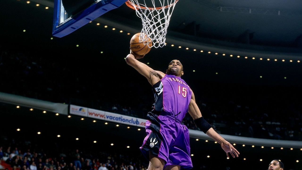 ORLANDO, FL - 2001: Vince Carter #15 of the Toronto Raptors soars for a dunk against Tracy McGrady #1 of the Toronto Raptors during a 2001 NBA Game at the TD Waterhouse Centre in Orlando, Florida. NOTE TO USER: User expressly acknowledges that, by downloading and or using this photograph, User is consenting to the terms and conditions of the Getty Images License agreement. Mandatory Copyright Notice: Copyright 2001 NBAE