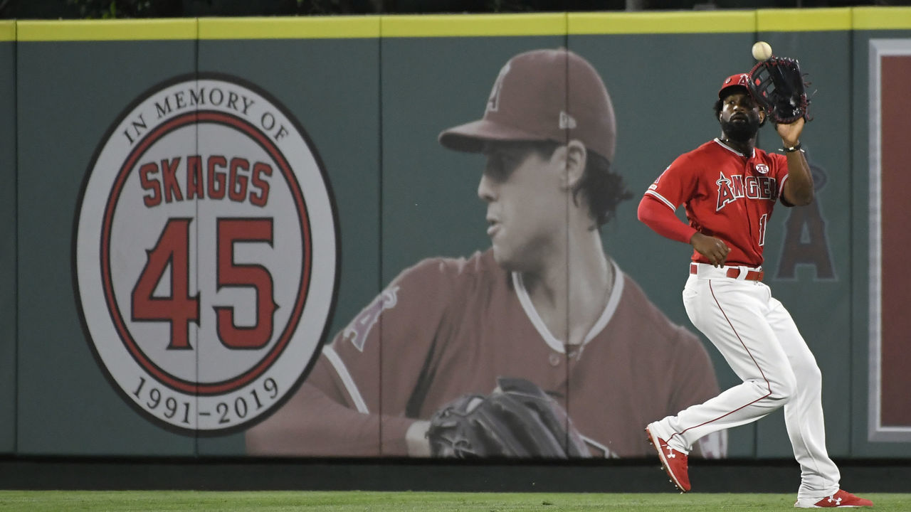 ANAHEIM, CA - JULY 17: Brian Goodwin #18 of the Los Angeles Angels of Anaheim catches a fly ball next to a memorial for Tyler Skaggs in center field hit by Yuli Gurriel #10 of the Houston Astros at Angel Stadium of Anaheim on July 17, 2019 in Anaheim, California. Astros won 12-2.