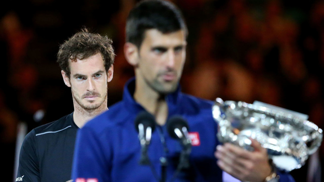 MELBOURNE, AUSTRALIA - JANUARY 31: Australian Open champion Novak Djokovic of Serbia holds the Norman Brookes Challenge Cup as Andy Murray of Great Britain looks on after the Men's Singles Final during day 14 of the 2016 Australian Open at Melbourne Park on January 31, 2016 in Melbourne, Australia.