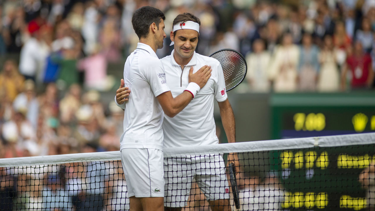 LONDON, ENGLAND - July 14: Roger Federer of Switzerland and winner Novak Djokovic of Serbia embrace at the net at the end of thee game during the Men's Singles Final on Centre Court during the Wimbledon Lawn Tennis Championships at the All England Lawn Tennis and Croquet Club at Wimbledon on July 14, 2019 in London, England.