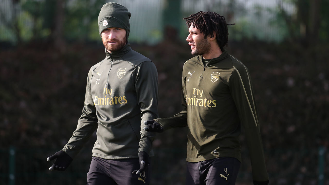 Arsenal's Shkodran Mustafi and Mohamed Elneny walk out to their training session at London Colney.