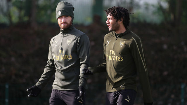 Arsenal's Shkodran Mustafi and Mohamed Elneny walk out to their training session at London Colney.