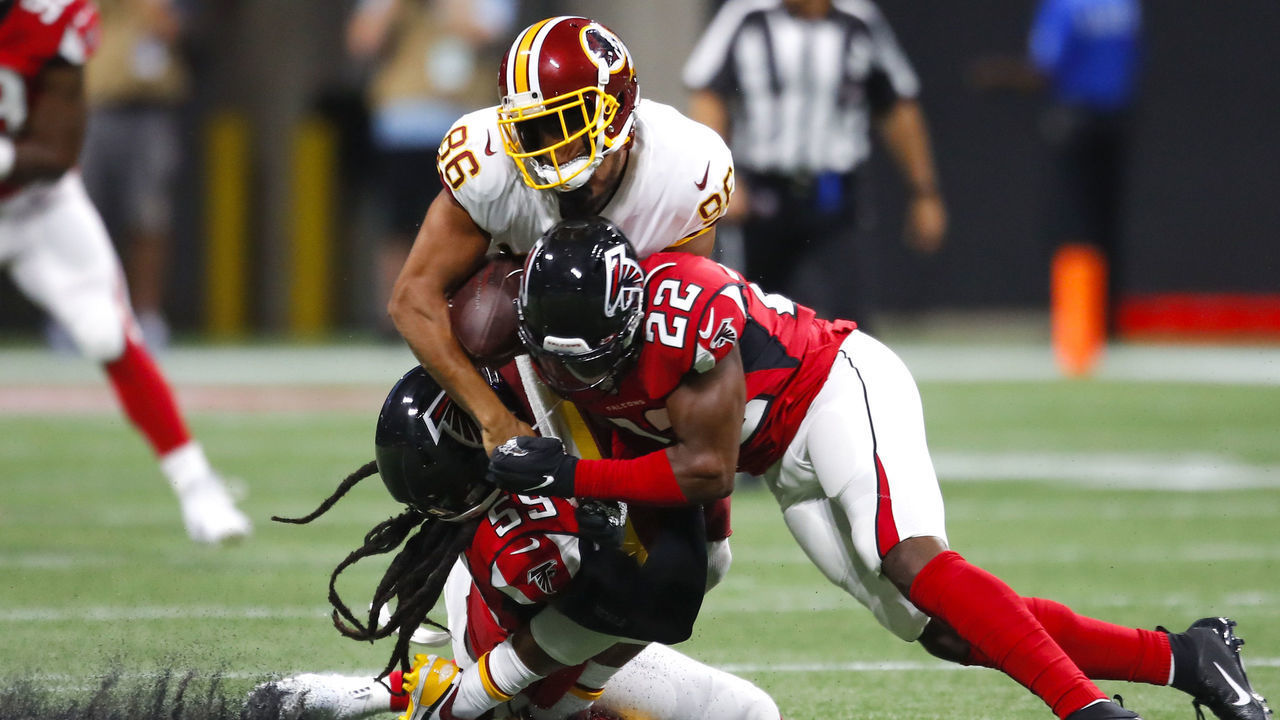 ATLANTA, GA - AUGUST 22: Tight end Jordan Reed #86 of the Washington Redskins is hit and loses his helmet by outside linebacker De'Vondre Campbell #59 of the Atlanta Falcons and strong safety Keanu Neal #22 in the first half of an NFL preseason game at Mercedes-Benz Stadium on August 22, 2019 in Atlanta, Georgia.