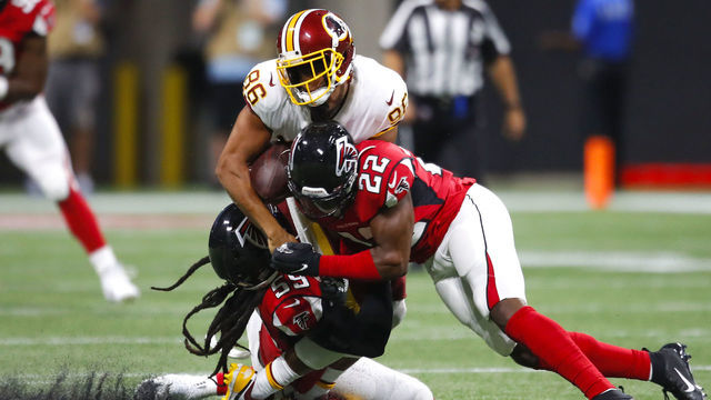 ATLANTA, GA - AUGUST 22: Tight end Jordan Reed #86 of the Washington Redskins is hit and loses his helmet by outside linebacker De'Vondre Campbell #59 of the Atlanta Falcons and strong safety Keanu Neal #22 in the first half of an NFL preseason game at Mercedes-Benz Stadium on August 22, 2019 in Atlanta, Georgia.