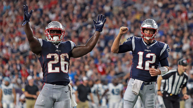 FOXBORO, MA. - AUGUST 22: Sony Michel #26 and Tom Brady #12 of the New England Patriots celebrate a touchdown during the second quarter of the NFL pre-season game against the Carolina Panthers at Gillette Stadium on August 22, 2019 in Foxboro, Massachusetts. (Staff Photo By Matt Stone/MediaNews Group/Boston Herald)