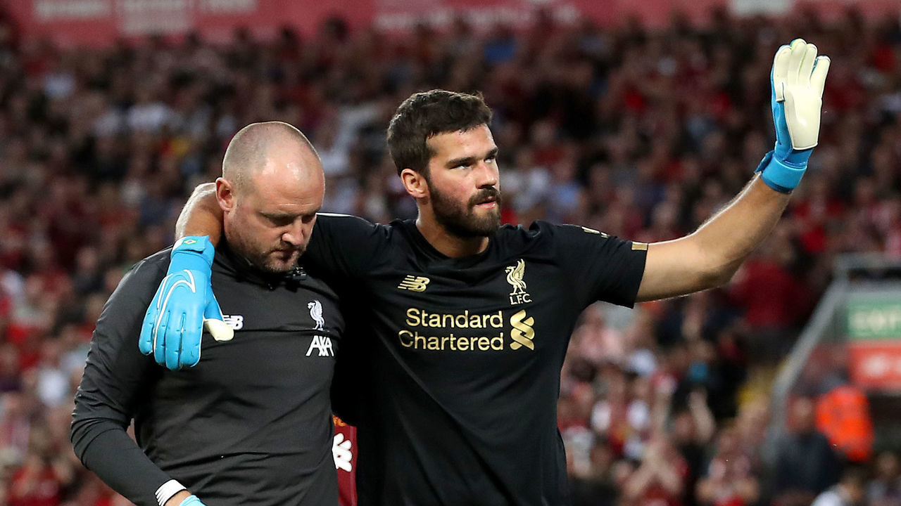 Liverpool goalkeeper Alisson (right) leaves the pitch after picking up an injury during the Premier League match at Anfield, Liverpool.