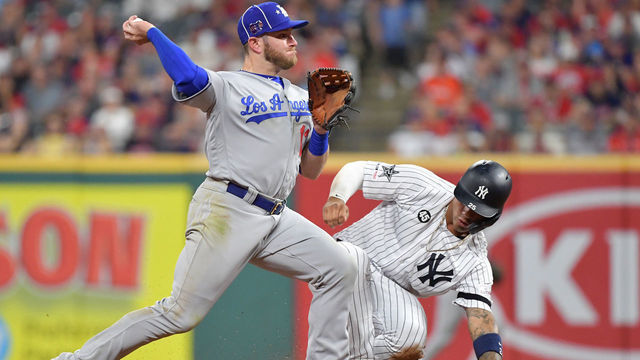 CLEVELAND, OHIO - JULY 09: Gleyber Torres #25 of the New York Yankees slides as Max Muncy #13 of the Los Angeles Dodgers looks to throw during the 2019 MLB All-Star Game at Progressive Field on July 09, 2019 in Cleveland, Ohio.