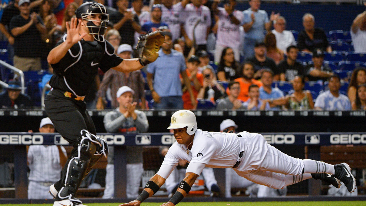 MIAMI, FL - AUGUST 23: Starlin Castro #13 of the Miami Marlins scores a run in the fifth inning against the Philadelphia Phillies at Marlins Park on August 23, 2019 in Miami, Florida. Teams are wearing special color schemed uniforms with players choosing nicknames to display for Players' Weekend.