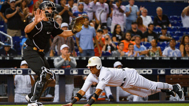 MIAMI, FL - AUGUST 23: Starlin Castro #13 of the Miami Marlins scores a run in the fifth inning against the Philadelphia Phillies at Marlins Park on August 23, 2019 in Miami, Florida. Teams are wearing special color schemed uniforms with players choosing nicknames to display for Players' Weekend.