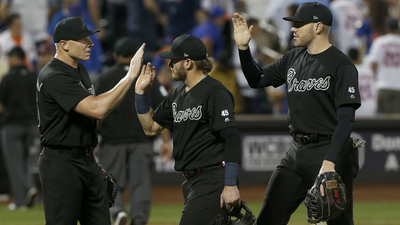 NEW YORK, NEW YORK - AUGUST 23: (L-R) Mark Melancon #36, Josh Donaldson #20 and Freddie Freeman #5 of the Atlanta Braves celebrate after defeating the New York Mets in fourteen innings at Citi Field on August 23, 2019 in New York City. Teams are wearing special color schemed uniforms with players choosing nicknames to display for Players Weekend.