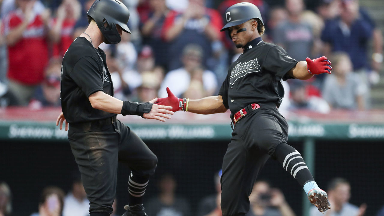 CLEVELAND, OH - AUGUST 23: Francisco Lindor #12 of the Cleveland Indians celebrates with Tyler Naquin #30 after hitting a two run home run off starting pitcher Jakob Junis #65 of the Kansas City Royals during the second inning at Progressive Field on August 23, 2019 in Cleveland, Ohio. Teams are wearing special color schemed uniforms with players choosing nicknames to display for Players' Weekend.