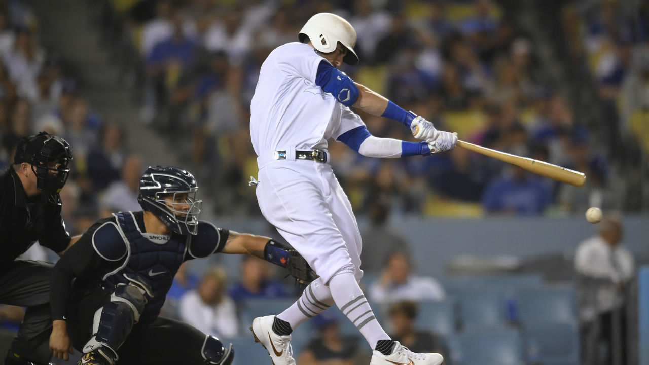 LOS ANGELES, CA - AUGUST 23: Gary Sanchez #24 of the New York Yankees catches as Cody Bellinger #35 of the Los Angeles Dodgers is at bat at Dodger Stadium on August 23, 2019 in Los Angeles, California. Teams are wearing special color schemed uniforms with players choosing nicknames to display for Players' Weekend. The Yankees won 10-2.