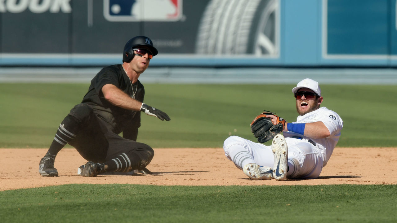 LOS ANGELES, CA - AUGUST 24: Los Angeles Dodgers second baseman Max Muncy (13) reacts after falling over New York Yankees center fielder Brett Gardner (11), who is safe at second base, while attempting to throw the ball to first base in the ninth inning of a game played on August 24, 2019 at Dodger Stadium on Los Angeles, CA.