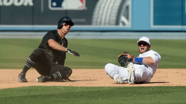 LOS ANGELES, CA - AUGUST 24: Los Angeles Dodgers second baseman Max Muncy (13) reacts after falling over New York Yankees center fielder Brett Gardner (11), who is safe at second base, while attempting to throw the ball to first base in the ninth inning of a game played on August 24, 2019 at Dodger Stadium on Los Angeles, CA.