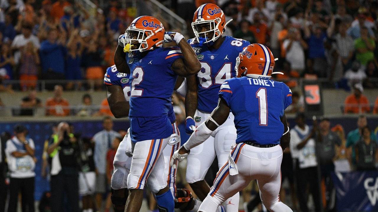 ORLANDO, FL - AUGUST 24: Lamical Perine #2 of the Florida Gators celebrates scoring a touchdown with teammates in the second half against the Miami Hurricanes in the Camping World Kickoff at Camping World Stadium on August 24, 2019 in Orlando, Florida.