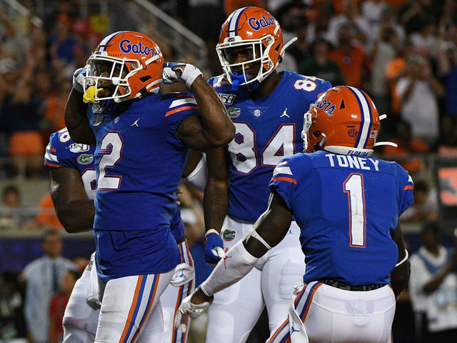 ORLANDO, FL - AUGUST 24: Lamical Perine #2 of the Florida Gators celebrates scoring a touchdown with teammates in the second half against the Miami Hurricanes in the Camping World Kickoff at Camping World Stadium on August 24, 2019 in Orlando, Florida.