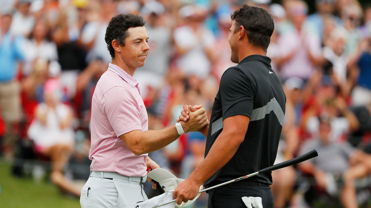 ATLANTA, GEORGIA - AUGUST 25: Brooks Koepka of the United States congratulates Rory McIlroy of Northern Ireland on the 18th green after McIlroy won the FedEx Cup and Tour Championship during the final round of the TOUR Championship at East Lake Golf Club on August 25, 2019 in Atlanta, Georgia.