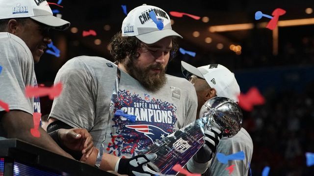Center for the New England Patriots David Andrews holds the trophy after winning Super Bowl LIII against the Los Angeles Rams at Mercedes-Benz Stadium in Atlanta, Georgia, on February 3, 2019.