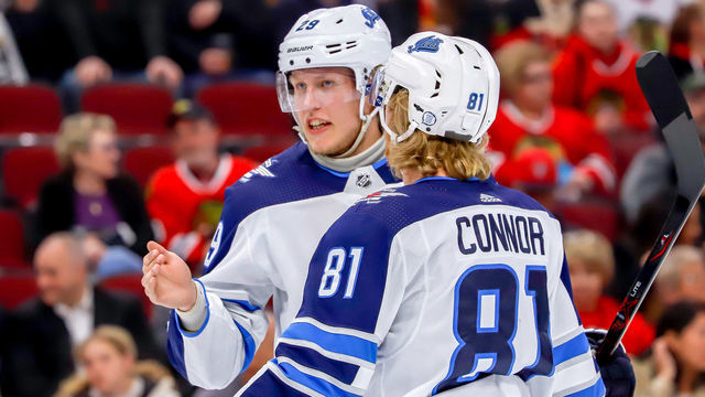CHICAGO, IL - APRIL 1: Patrik Laine #29 and Kyle Connor #81 of the Winnipeg Jets discuss strategy during a first period stoppage in play against the Chicago Blackhawks at the United Center on April 1, 2019 in Chicago, Illinois.