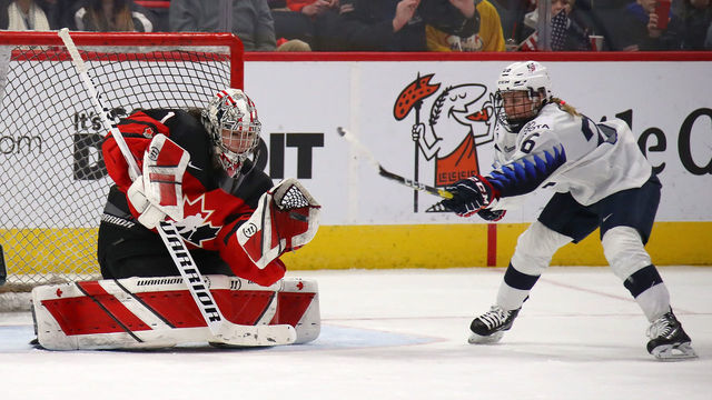 DETROIT, MICHIGAN - FEBRUARY 17: Shannon Szabados #1 of Canada makes a save next to Kendall Coyne Schofield #26 of the United States during the second period at Little Caesars Arena on February 17, 2019 in Detroit, Michigan.
