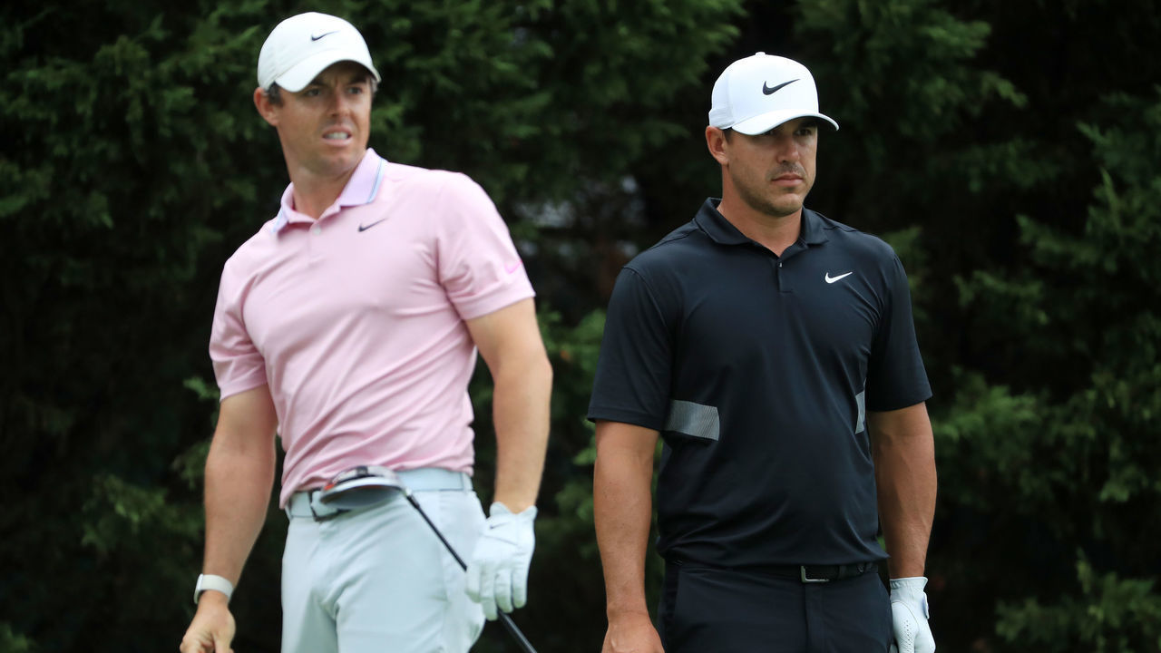 ATLANTA, GEORGIA - AUGUST 25: Brooks Koepka of the United States and Rory McIlroy of Northern Ireland look on from the eighth tee during the final round of the TOUR Championship at East Lake Golf Club on August 25, 2019 in Atlanta, Georgia.