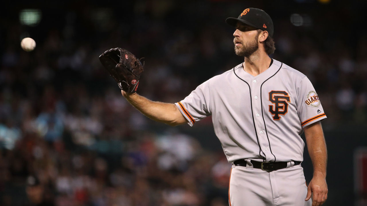 PHOENIX, ARIZONA - AUGUST 18: Starting pitcher Madison Bumgarner #40 of the San Francisco Giants catches a throw back during the third inning of the MLB game against the Arizona Diamondbacks at Chase Field on August 18, 2019 in Phoenix, Arizona.