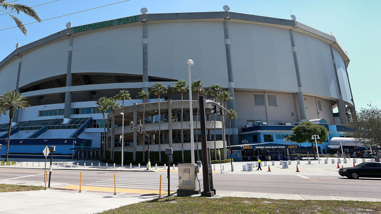 ST. PETERSBURG, FL - MARCH 29: Pedestrians pass along the sidewalk outside of Tropicana Field in St. Petersburg, FL on the morning of March 29, 2018, where the Boston Red Sox will visit the Tampa Bay Rays for Opening Day of the 2018 MLB baseball season.