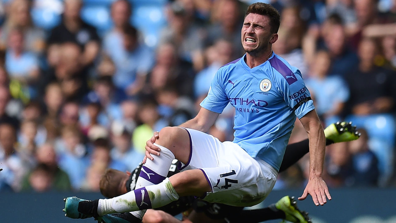 Manchester City's French defender Aymeric Laporte picks up an injury in a challenge with Brighton's English defender Adam Webster during the English Premier League football match between Manchester City and Brighton and Hove Albion at the Etihad Stadium in Manchester, north west England, on August 31, 2019.