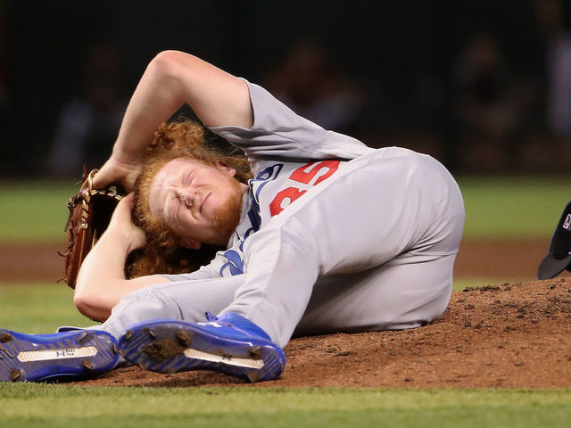 Los Angeles Dodgers' Dustin May takes liner off head during game