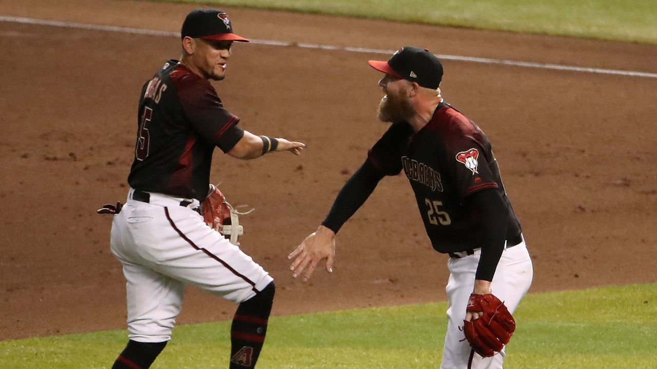PHOENIX, ARIZONA - AUGUST 31: Relief pitcher Archie Bradley #25 of the Arizona Diamondbacks celebrates with Ildemaro Vargas #15 after defeating the Los Angeles Dodgers 6-5 in the MLB game at Chase Field on August 31, 2019 in Phoenix, Arizona.