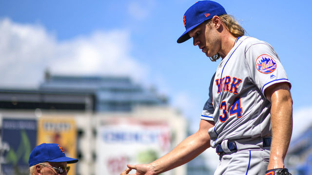 WASHINGTON, DC - SEPTEMBER 02: New York Mets starting pitcher Noah Syndergaard (34) is congratulated by New York Mets interim pitching coach Phil Regan (58) after completing the seventh inning against the Washington Nationals on September 2, 2019, at Nationals Park, in Washington D.C.