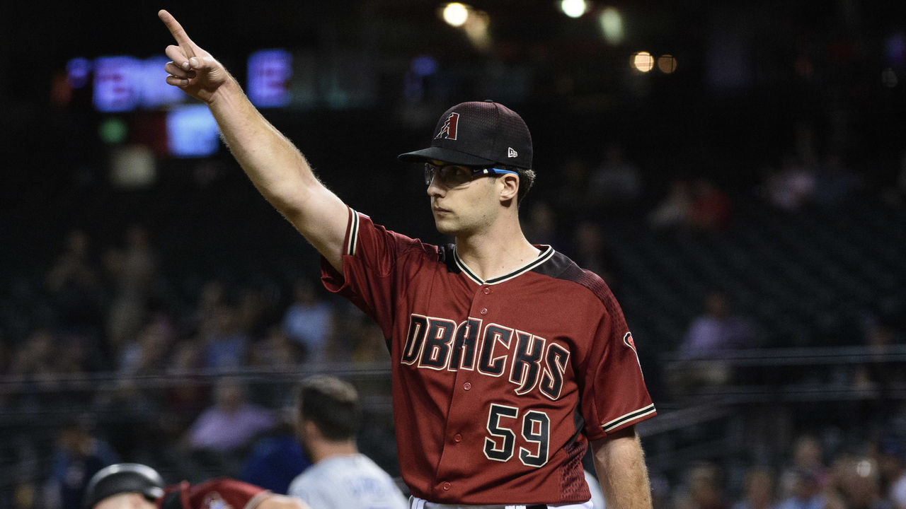 PHOENIX, ARIZONA - SEPTEMBER 04: Zac Gallen #59 of the Arizona Diamondbacks points to left fielder Josh Rojas (not pictured) after making the throw to home plate for an out in first inning of the MLB game against the San Diego Padres at Chase Field on September 04, 2019 in Phoenix, Arizona.