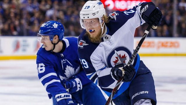 TORONTO, ON - MARCH 31: Patrik Laine #29 of the Winnipeg Jets passes Mitchell Marner #16 of the Toronto Maple Leafs during the third period at the Air Canada Centre on March 31, 2018 in Toronto, Ontario, Canada.
