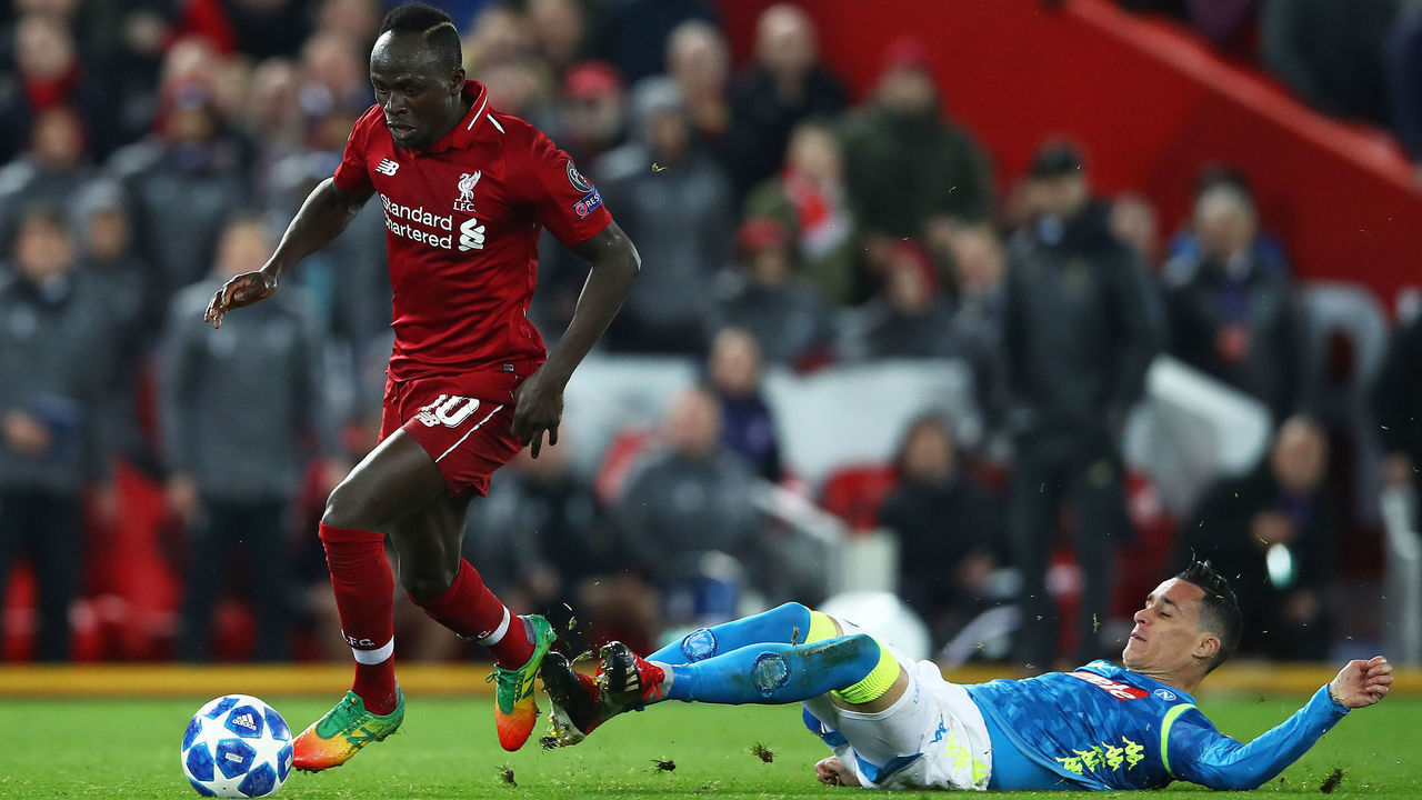 LIVERPOOL, ENGLAND - DECEMBER 11: Sadio Mane of Liverpool evades Jose Callejon of Napoli during the UEFA Champions League Group C match between Liverpool and SSC Napoli at Anfield on December 11, 2018 in Liverpool, United Kingdom.