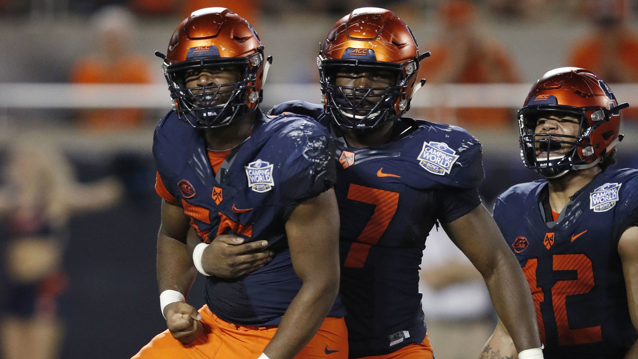 ORLANDO, FL - DECEMBER 28: Kendall Coleman #55 of the Syracuse Orange celebrates with Brandon Berry #97 after a sack against the West Virginia Mountaineers in the fourth quarter of the Camping World Bowl at Camping World Stadium on December 28, 2018 in Orlando, Florida.