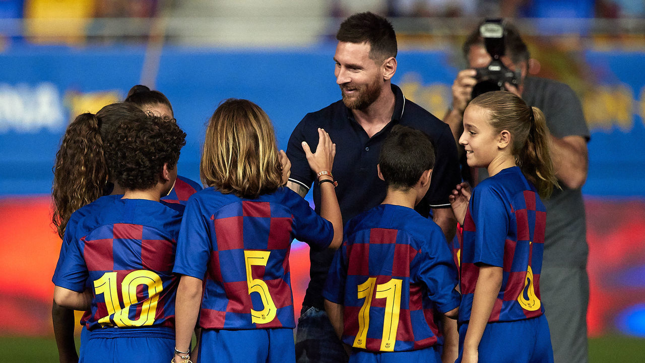 BARCELONA, SPAIN - AUGUST 27: Lionel Messi of FC Barcelona shakes hands with young FC Barcelona players prior a friendly match between FC Barcelona U19 and Ajax U19 at the new Johan Cruyff stadium on August 27, 2019 in Barcelona, Spain.