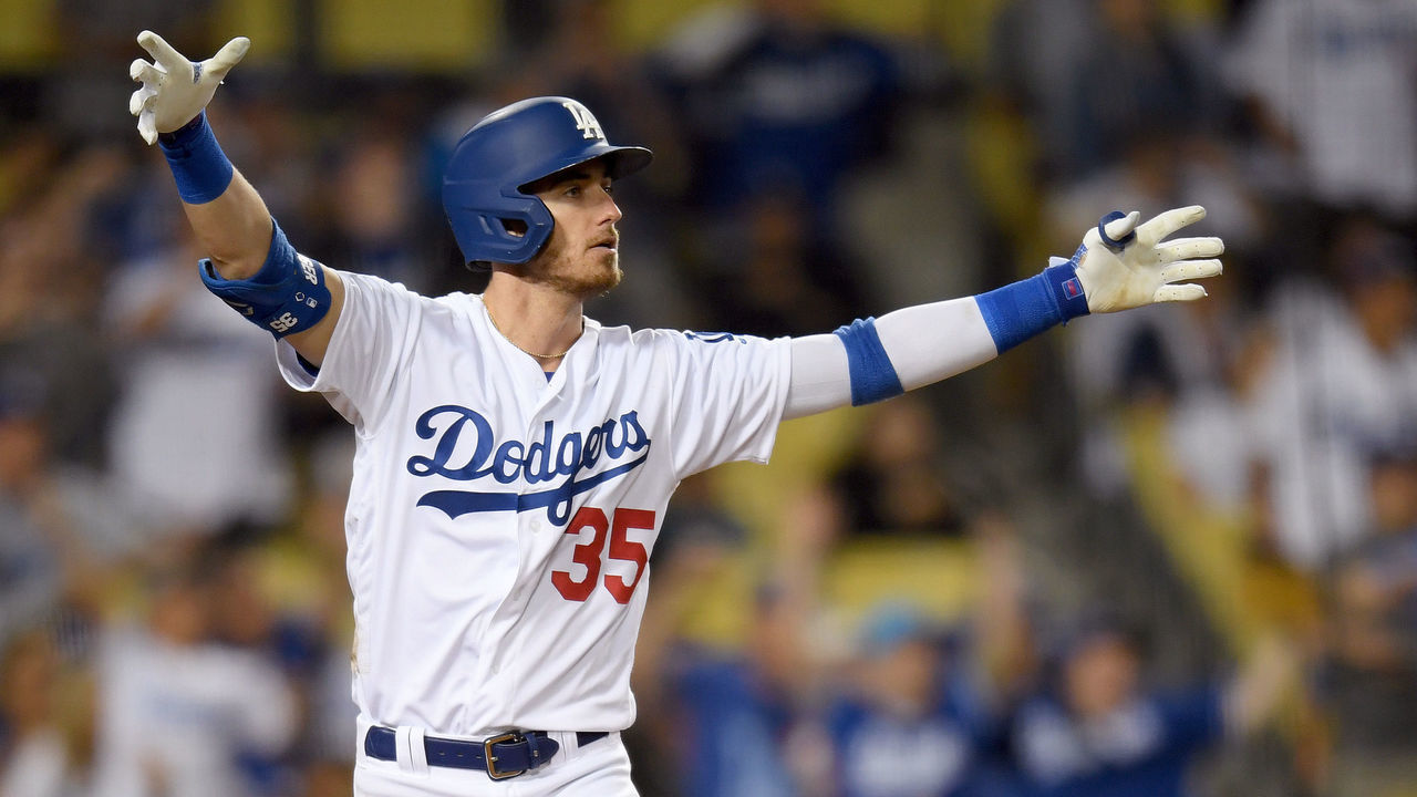 LOS ANGELES, CALIFORNIA - JULY 03: Cody Bellinger #35 of the Los Angeles Dodgers reacts to his walk-off solo homerun in front of Carson Kelly #18 of the Arizona Diamondbacks, for a 5-4 win, during the tenth inning at Dodger Stadium on July 03, 2019 in Los Angeles, California.