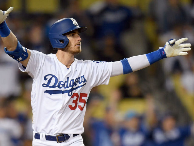 LOS ANGELES, CALIFORNIA - JULY 03: Cody Bellinger #35 of the Los Angeles Dodgers reacts to his walk-off solo homerun in front of Carson Kelly #18 of the Arizona Diamondbacks, for a 5-4 win, during the tenth inning at Dodger Stadium on July 03, 2019 in Los Angeles, California.