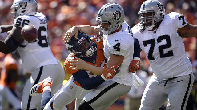 DENVER, CO - SEPTEMBER 16, 2018: Linebacker Von Miller (58) of the Denver Broncos forces a fumble on quarterback Derek Carr (4) of the Oakland Raiders during the first quarter on Sunday, September 16 at Broncos Stadium at Mile High. The ball was recovered by defensive tackle Domata Sr. Peko (94) of the Denver Broncos but the play was called back. The Denver Broncos hosted the Oakland Raiders for the second game of the season.