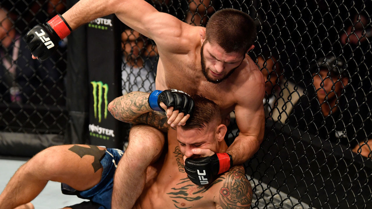ABU DHABI, UNITED ARAB EMIRATES - SEPTEMBER 07: Khabib Nurmagomedov of Russia (top) punches Dustin Poirier in their lightweight championship bout during UFC 242 at The Arena on September 7, 2019 in Yas Island, Abu Dhabi, United Arab Emirates.