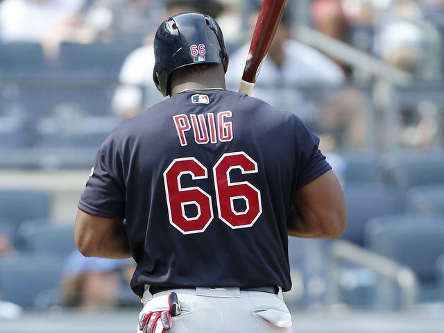 Cleveland Indians Carlos Santana and Yasiel Puig in the dugout after  scoring in the 3rd against the Angels at Angel…