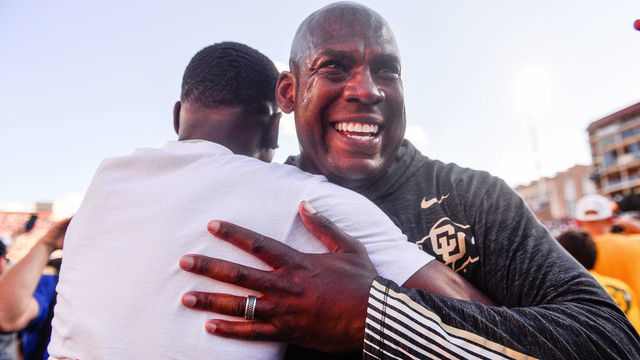 BOULDER, CO - SEPTEMBER 7: Head coach Mel Tucker of the Colorado Buffaloes hugs a fan who had rushed the field after the Colorado Buffaloes 34-31 overtime win over the Nebraska Cornhuskers at Folsom Field on September 7, 2019 in Boulder, Colorado.