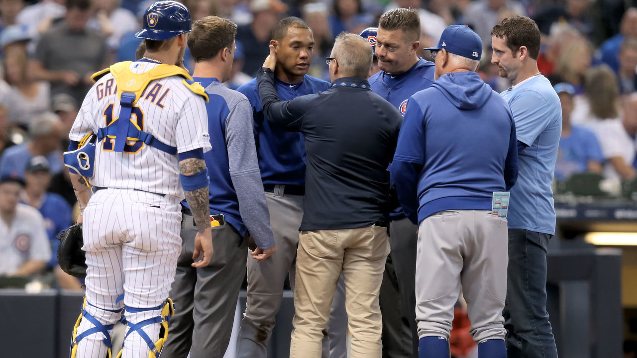 MILWAUKEE, WISCONSIN - SEPTEMBER 08: Addison Russell #27 of the Chicago Cubs is attended to after being hit by a pitch in the third inning against the Milwaukee Brewers at Miller Park on September 08, 2019 in Milwaukee, Wisconsin.