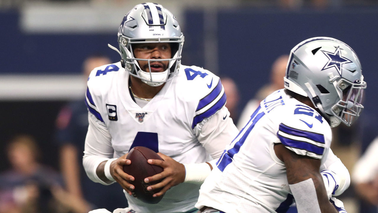 ARLINGTON, TEXAS - SEPTEMBER 08: Quarterback Dak Prescott #4 of the Dallas Cowboys fakes to running back Ezekiel Elliott #21 from the pocket during the first quarter of the game against New York Giants at AT&T Stadium on September 08, 2019 in Arlington, Texas.