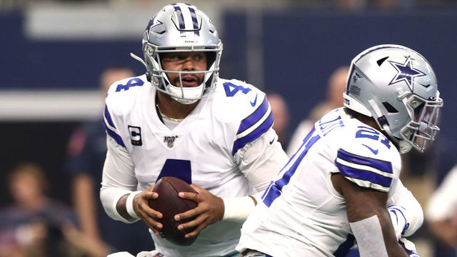 ARLINGTON, TEXAS - SEPTEMBER 08: Quarterback Dak Prescott #4 of the Dallas Cowboys fakes to running back Ezekiel Elliott #21 from the pocket during the first quarter of the game against New York Giants at AT&T Stadium on September 08, 2019 in Arlington, Texas.
