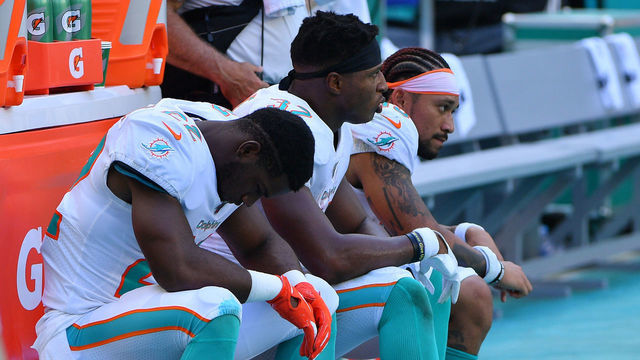 MIAMI, FLORIDA - SEPTEMBER 08: Mark Walton #22, Kenyan Drake #32 and Albert Wilson #15 of the Miami Dolphins look on in the fourth quarter against the Baltimore Ravens at Hard Rock Stadium on September 08, 2019 in Miami, Florida.