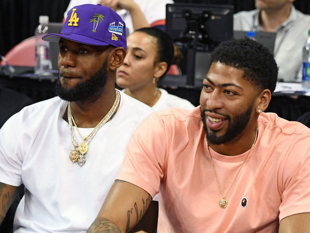 LAS VEGAS, NEVADA - JULY 05: NBA players LeBron James (L) and Anthony Davis watch a game between the New Orleans Pelicans and the New York Knicks during the 2019 NBA Summer League at the Thomas & Mack Center on July 5, 2019 in Las Vegas, Nevada.