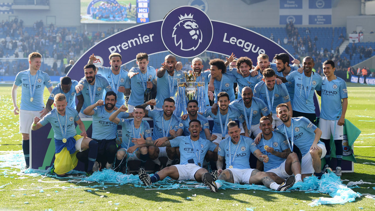 BRIGHTON, ENGLAND - MAY 12: Manchester City players celebrate with the Premier League Trophy after winning the title during the Premier League match between Brighton & Hove Albion and Manchester City at American Express Community Stadium on May 12, 2019 in Brighton, United Kingdom.