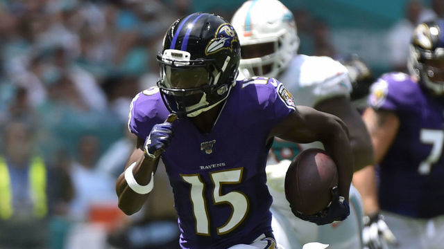 MIAMI, FL - SEPTEMBER 08: Marquise Brown #15 of the Baltimore Ravens catches a 47 yard touchdown pass from Lamar Jackson #8 in the first quarter against the Miami Dolphins at Hard Rock Stadium on September 8, 2019 in Miami, Florida.